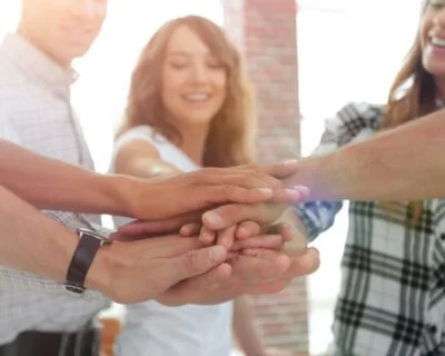 Happy people hands together